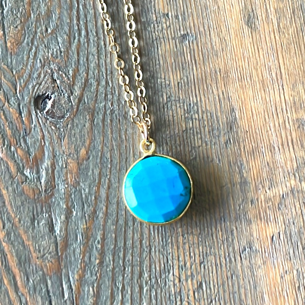 Small turquoise howlite bezel dangles from a gold filled chain